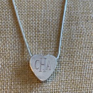 Sterling or sterling plated heart charm with CAH initials. Reversible.